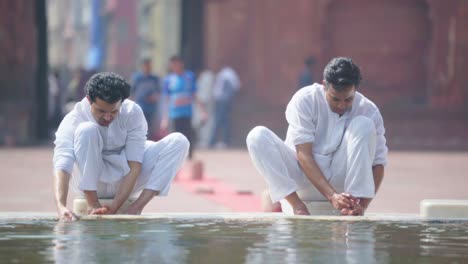 wuzu cleansing being done at a mosque by two indian muslims before praying