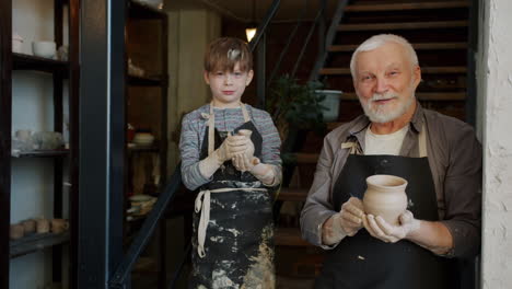 grandfather and grandson working on pottery