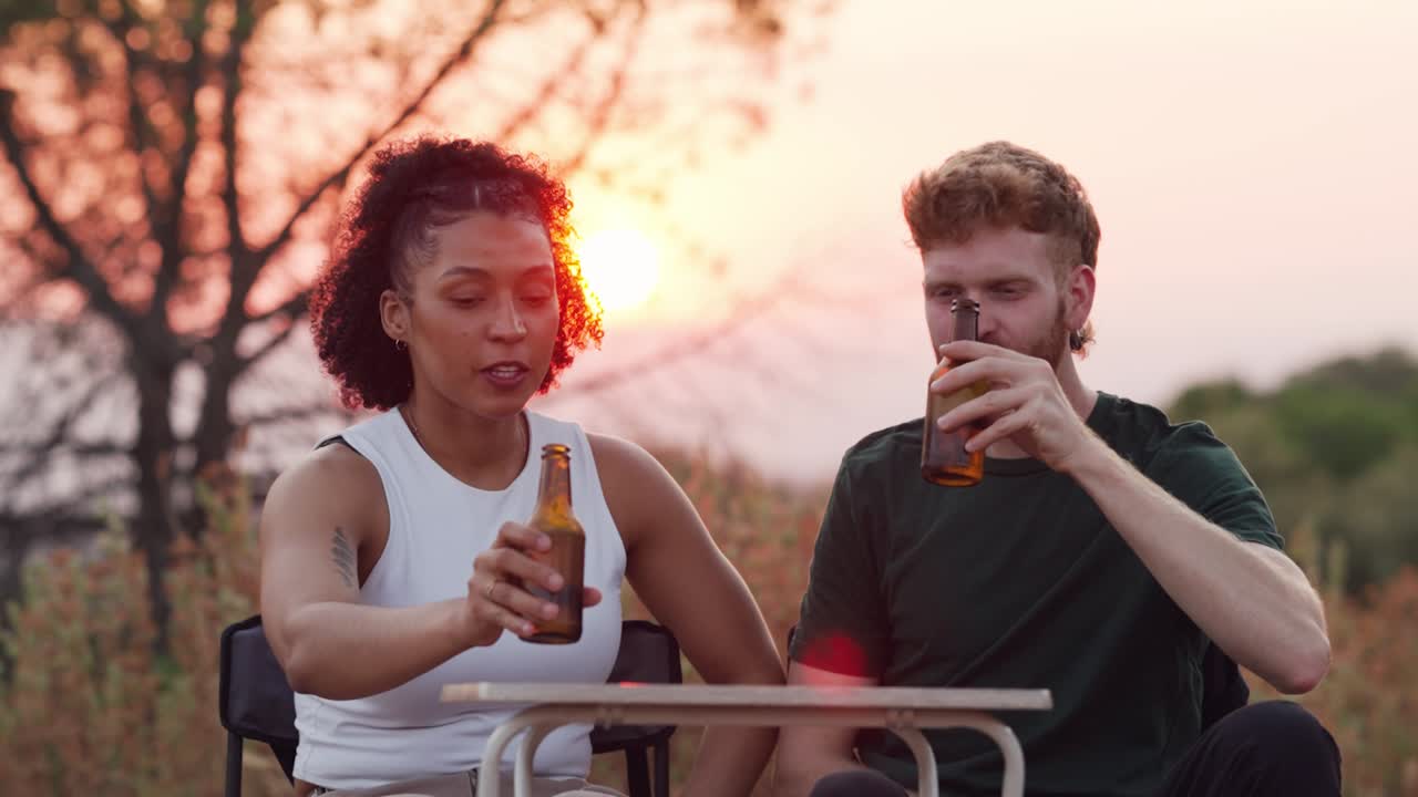 Friends enjoying beers at sunset