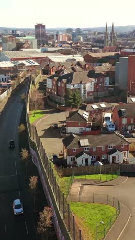 forward travelling social ratio aerial video of the belfast peace walls on a bright sunny day. filmed in 1080x1920 social ratio, 60fps and with rec709 color