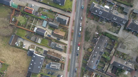 top down aerial of empty road through a beautiful small town