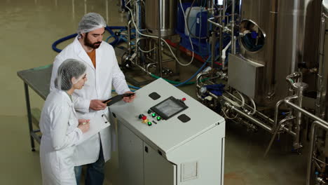 man and woman doing control at brewery