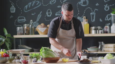 chef preparing a salad in a kitchen