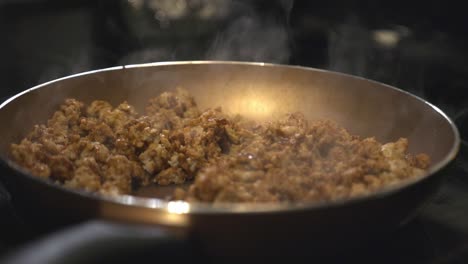 cooking meat in the non-stick pan and adding some oil from the yellow bottle