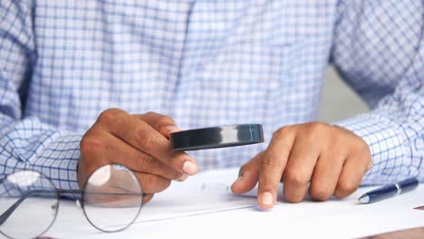 person reviewing documents with magnifying glass