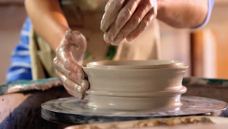 hands of female potter making a pot
