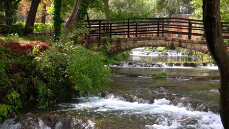 A-bridge-spanning-over-a-series-of-waterfalls-along-a-stream-in-Krka-National-Park-in-Croatia