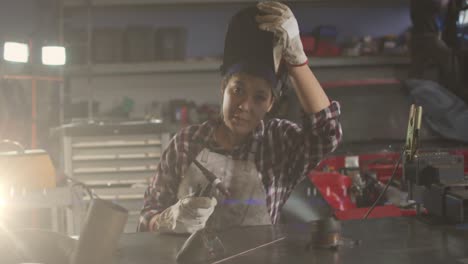 animation of light trails over biracial female mechanic reapiring car