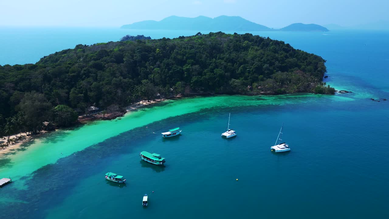 Koh Wai Bay Beach with boats anchored in turquoise waters. Smooth aerial view flight drone shot footage from above