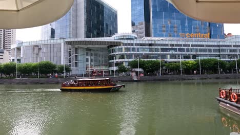 tourist boat cruising along a city river.