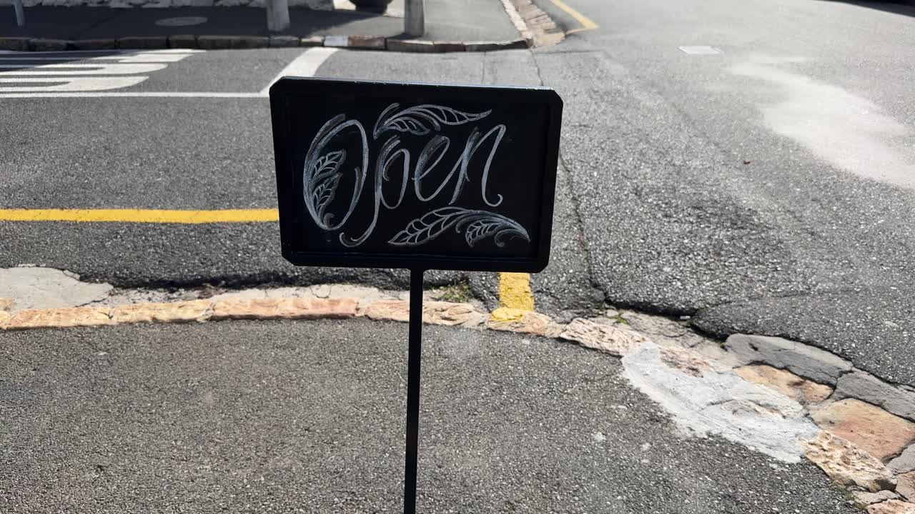 An open signage outside a quaint little coffee shop in Cape Town’s Southern Suburbs.