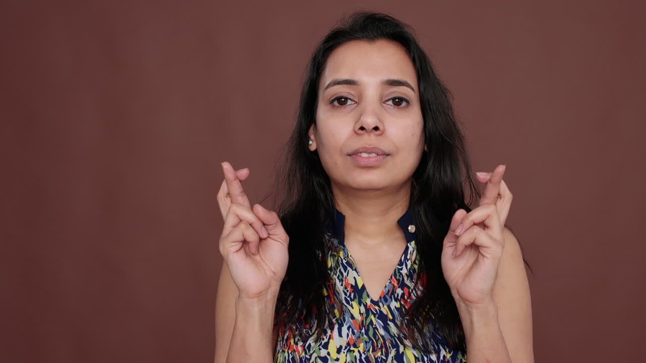 Young adult feeling hopeful about wish praying for good luck