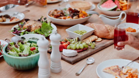 table, food and hand of man at a family lunch