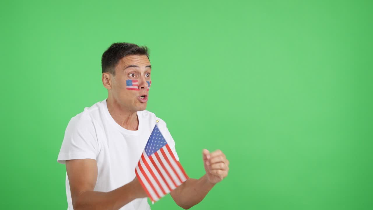United States supporter screaming and waving a national flag looking away