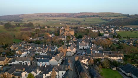 Aerial-footage-of-the-Medieval-village-of-Cartmel-in-the-English-Lake-District-it-has-a-rich-heritage,-and-varied-list-of-activities-for-visitors-and-tourists