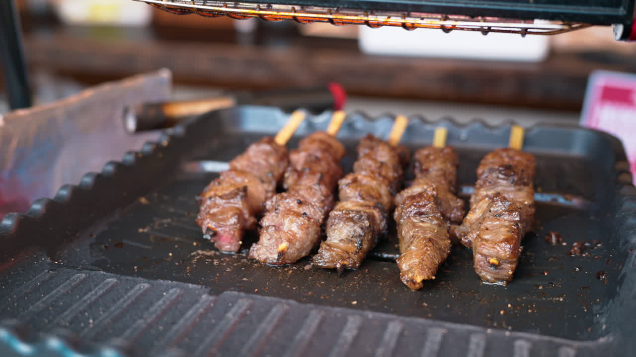 Close up of grilled meat on skewers at the Tsukiji Fish Market in Japan