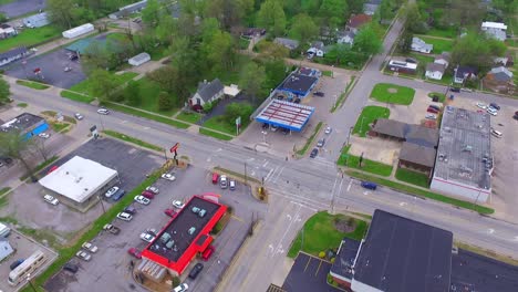 aerial view of an stoplight intersection with cars traveling through during the daytime