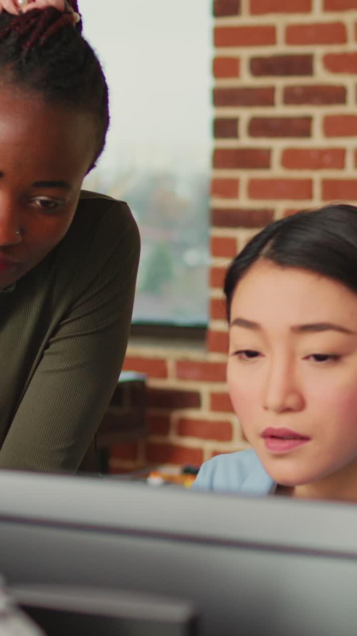 Vertical video: Diverse colleagues brainstorming ideas to create 3d content