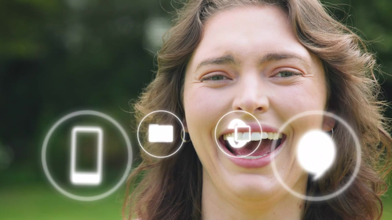 Woman smiling laughing in park, UI icons slide left, mail aligning near mouth reacting to messages
