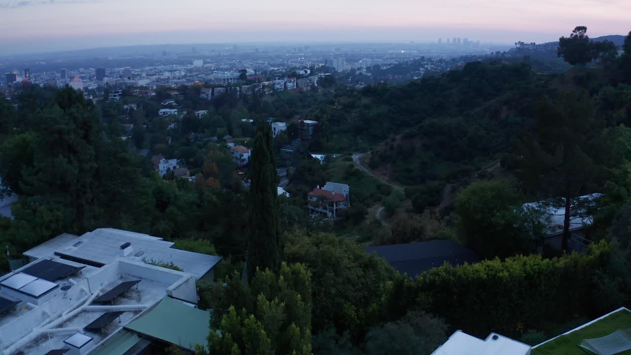 Low panning aerial shot of downtown Hollywood from Hollywood Hills at magic hour in Los Angeles, California. 4K at 30 FPS