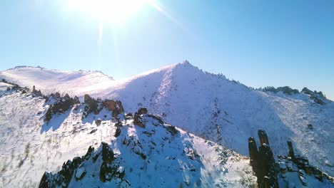 Drone-filming-of-a-winter-mountain-ridge-in-sunny-weather-4k