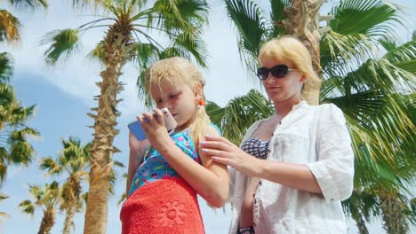 a woman wipes the baby after swimming in the pool