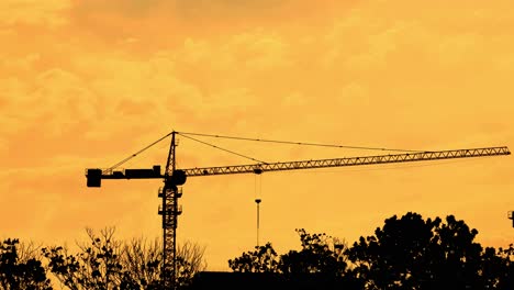 Silhouette-of-tower-crane-during-sunset