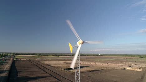 windmill spinning on a sunny day in rural texas