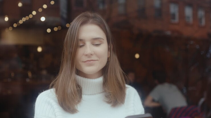 Woman in a cafe using a smartphone