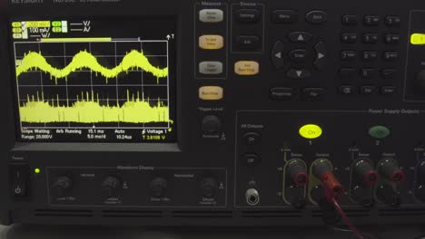 oscilloscope and power supply displaying waveforms