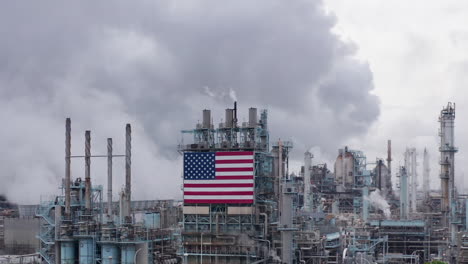 Clouds-of-Air-Pollution-at-American-Oil-Factory,-Aerial-Flying-Backward