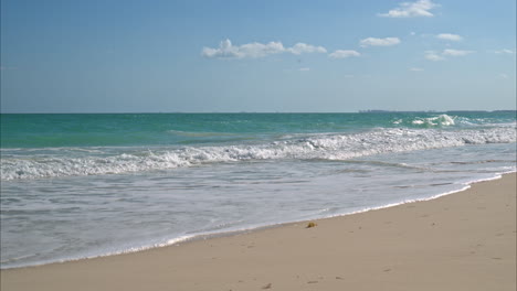 slow motion of the waves splashing at a beach near cancun mexico on a warm sunny day