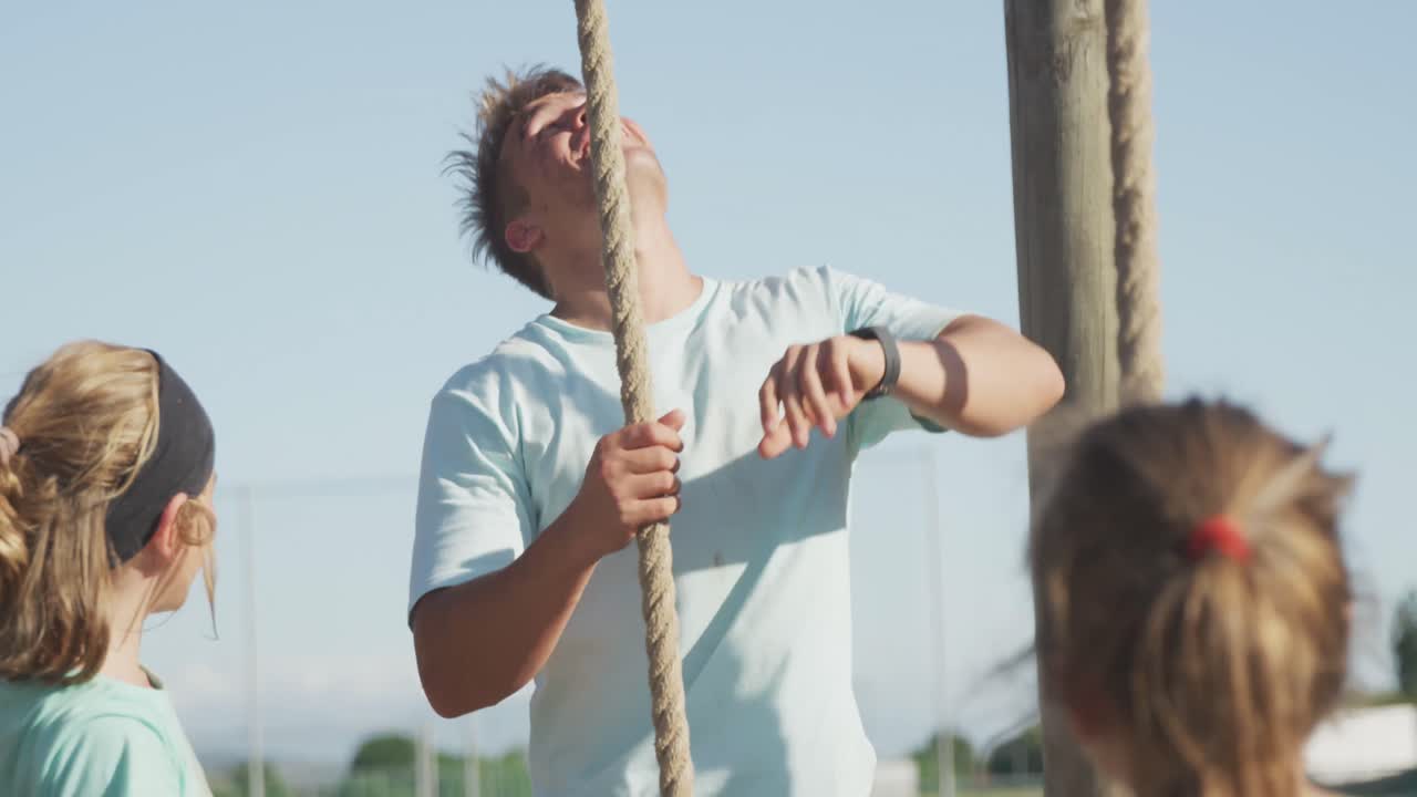 Caucasian coach instructing kids at boot camp
