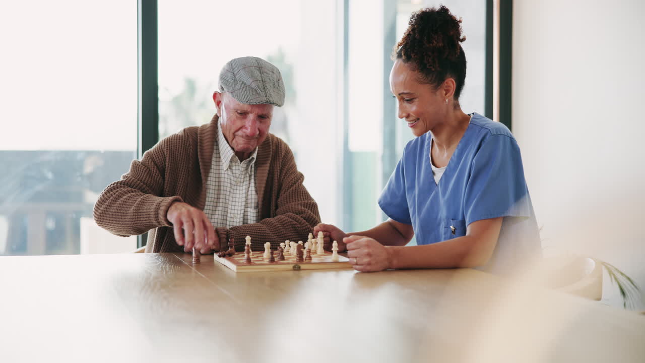 Elderly man playing chess with caregiver