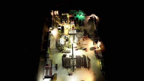 Top-View-Of-Oil-And-Gas-Drilling-Station-At-Nighttime---drone-shot