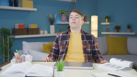 frustrated student turns off his laptop and stops doing homework.