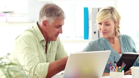  Smiling designer team using laptop
