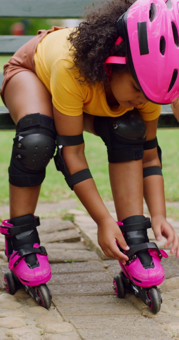 Young Girl Putting on Roller Skates in a Park