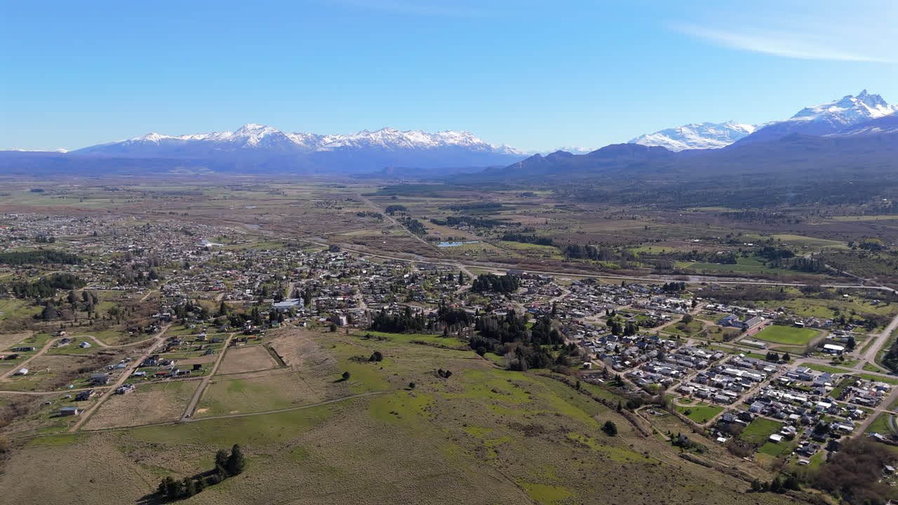 Establishing drone shot of Trevelin with snowy mountains in Patagonia, Argentina