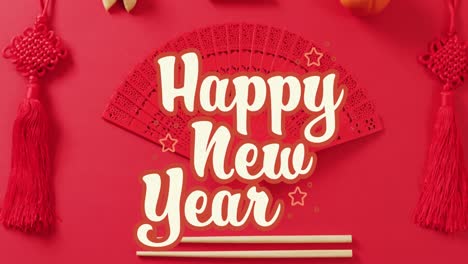 Animation-of-new-year-greetings-text-over-chinese-traditional-decorations-on-red-background