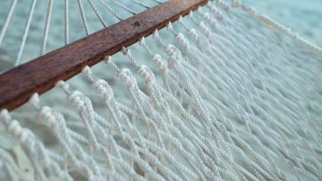 hammock swinging with wind breeze in sandy summer resort, close up