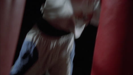 a boxer works out on a punching bag 1