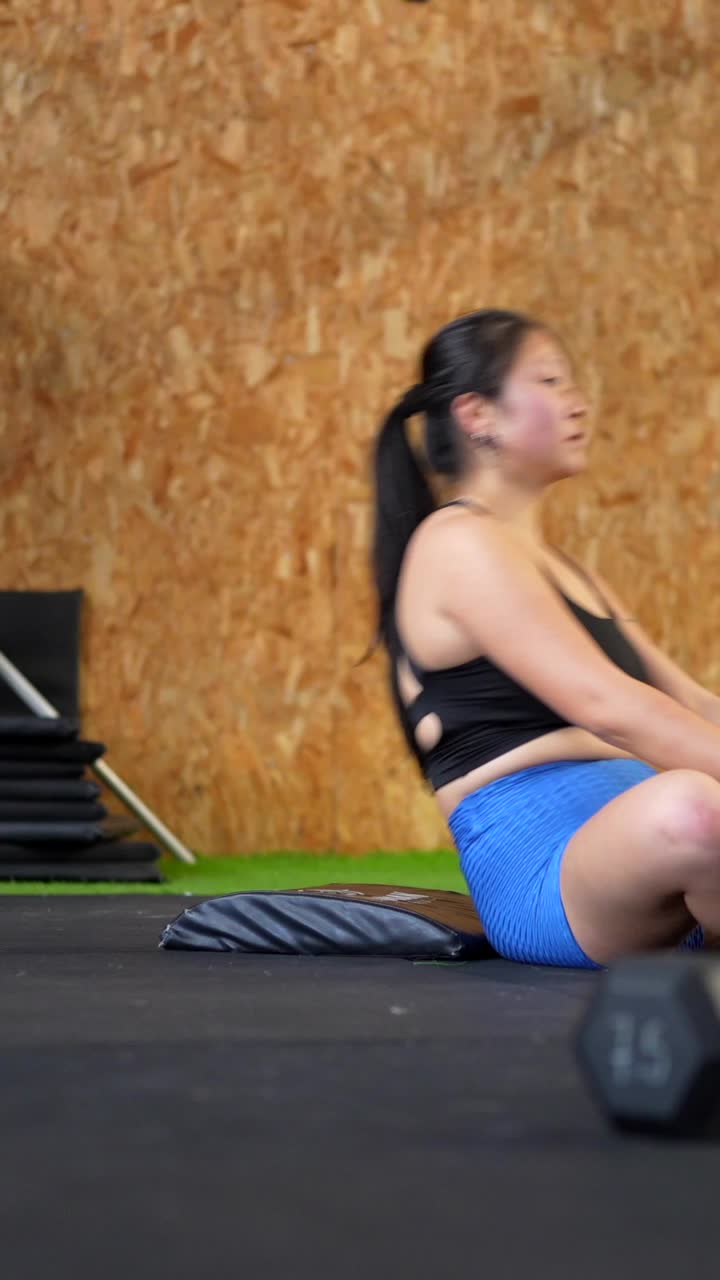 Woman exercising with ab mat in gym