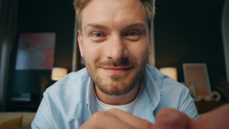 Positive-man-cool-gesturing-web-camera-view.-Laughing-guy-showing-big-finger