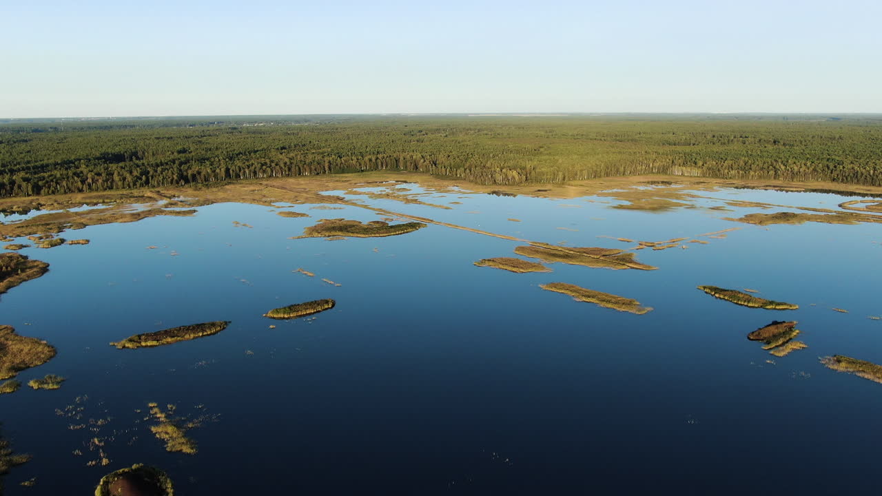 Crystal clear lake with thousands of tiny islands in Lithuania, aerial drone view