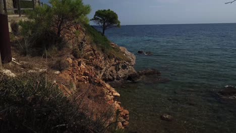 little beach with very calm waves at cami de ronda from port de la selva to llanç?