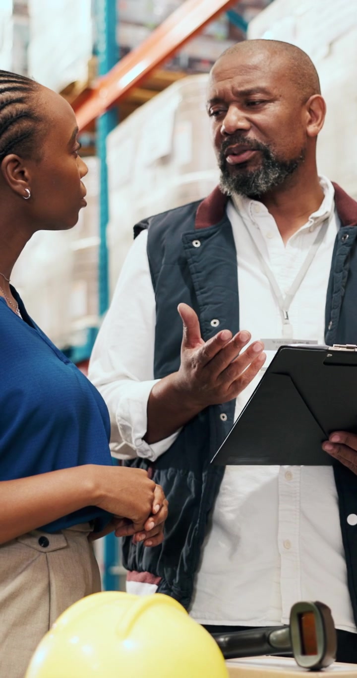 Warehouse Manager Discussing Inventory with Employee