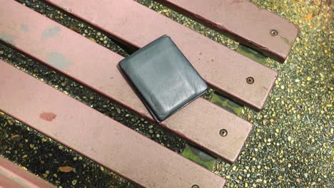 left wallet on a bench in the park ,