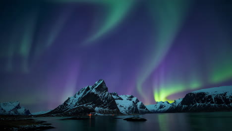stunning northern lights dance above snow-capped mountains and fjord