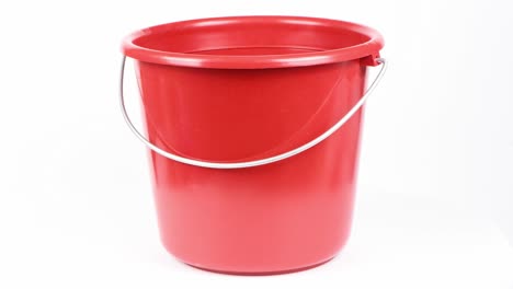 red bucket isolated on white background. side view. loop motion. rotation 360.